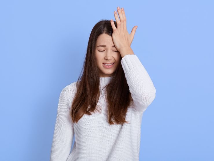 donna che si mette una mano in fronte perché ha dimenticato qualcosa